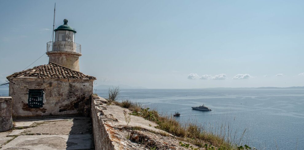 A lighthouse sits on a rocky cliff overlooking the ocean